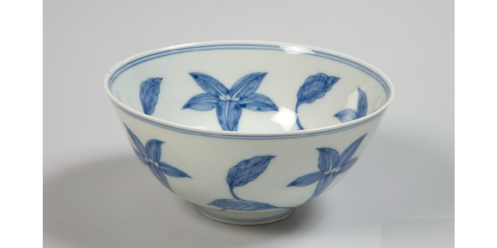 white bowl painted with blue flowers